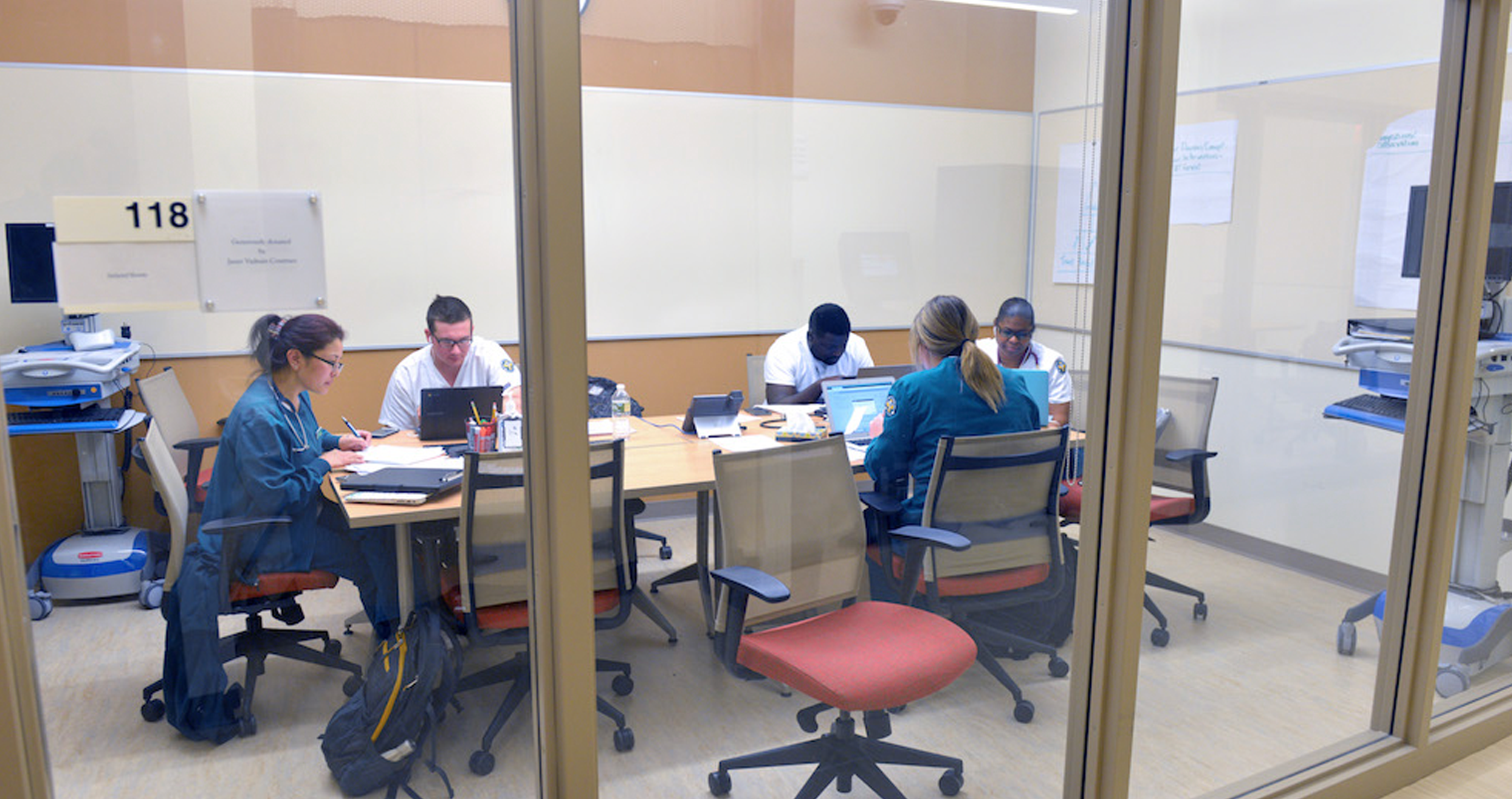 Healthcare students study together in a conference room